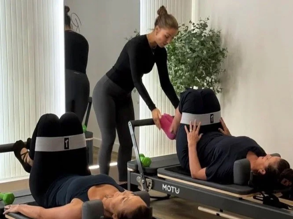 Reformer Pilates instructor guiding a client at Ascension Reformer Pilates