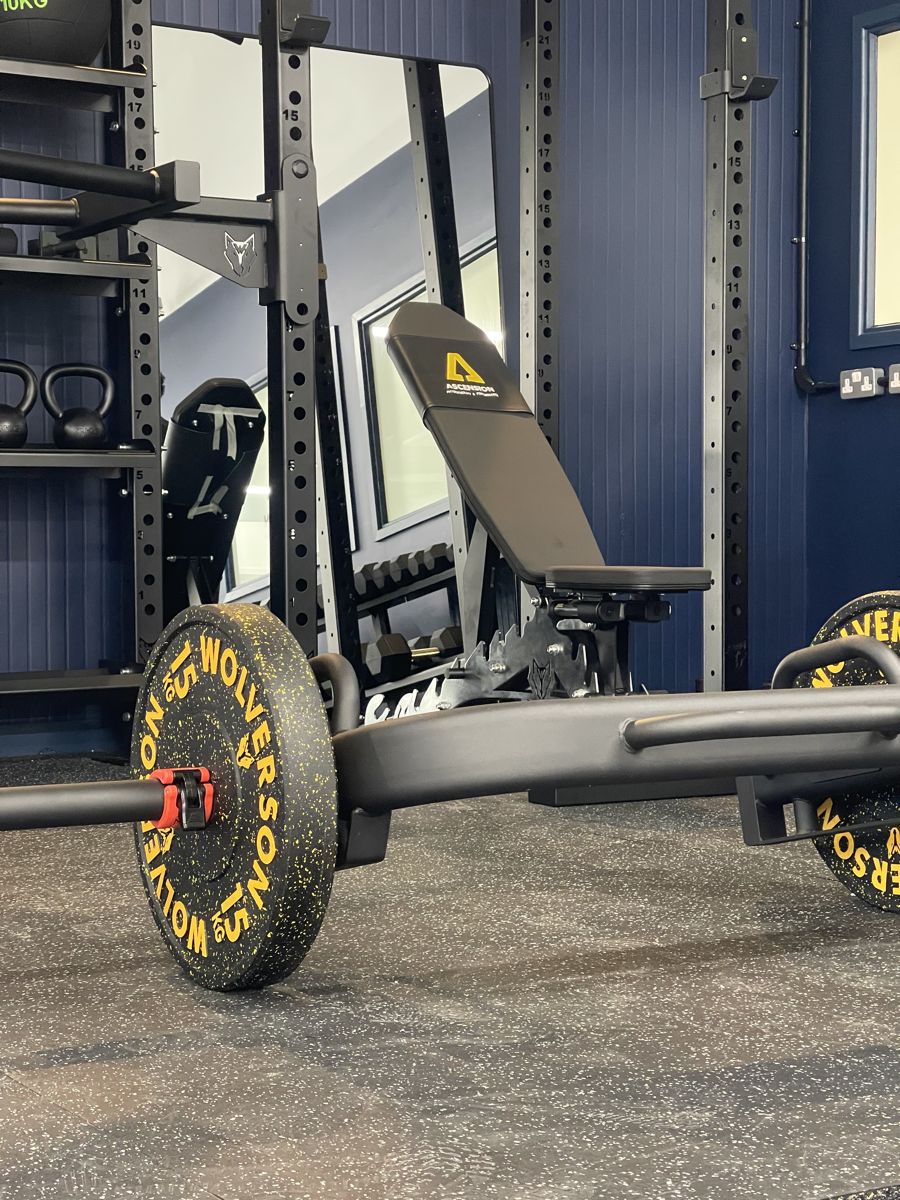 Loaded barbell and weight bench in the performance gym at Ascension Physiotherapy & Performance
