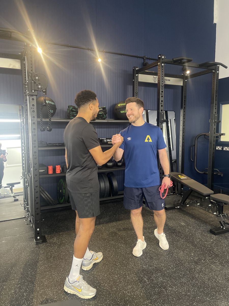 Coach and athlete bumping fists after a training session at Ascension Physiotherapy & Performance