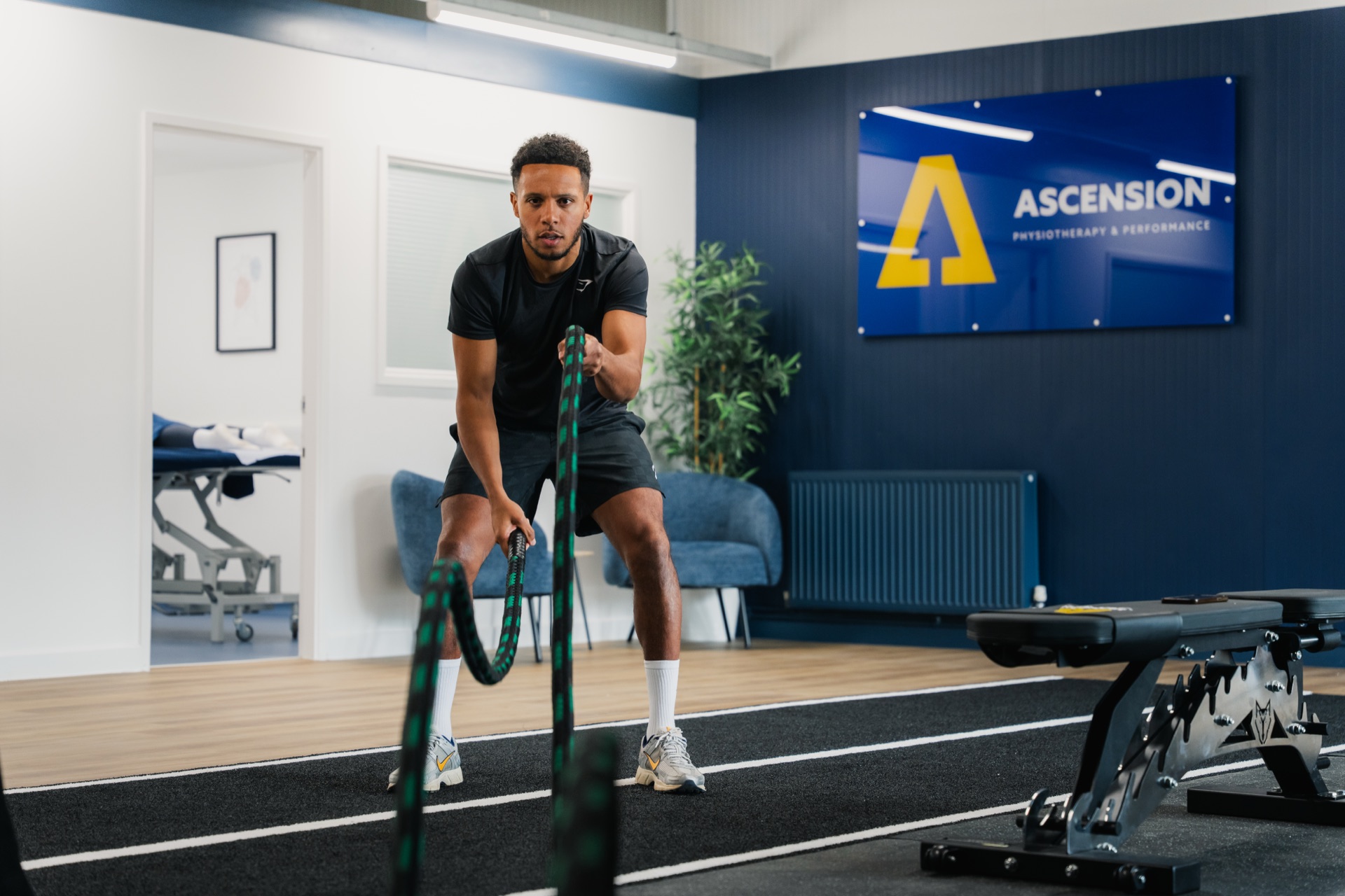 Athlete working with battle ropes during a conditioning session at Ascension Physiotherapy & Performance