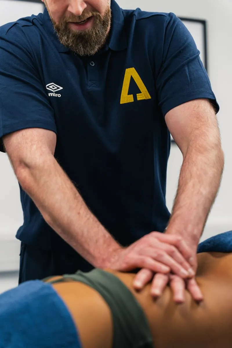 Therapist giving a hands-on sports massage to a client's lower back at Ascension Physiotherapy & Performance