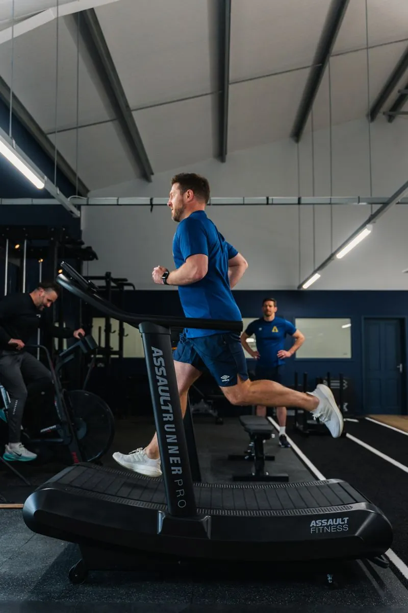 Client running on a curved treadmill in the performance gym at Ascension Physiotherapy & Performance