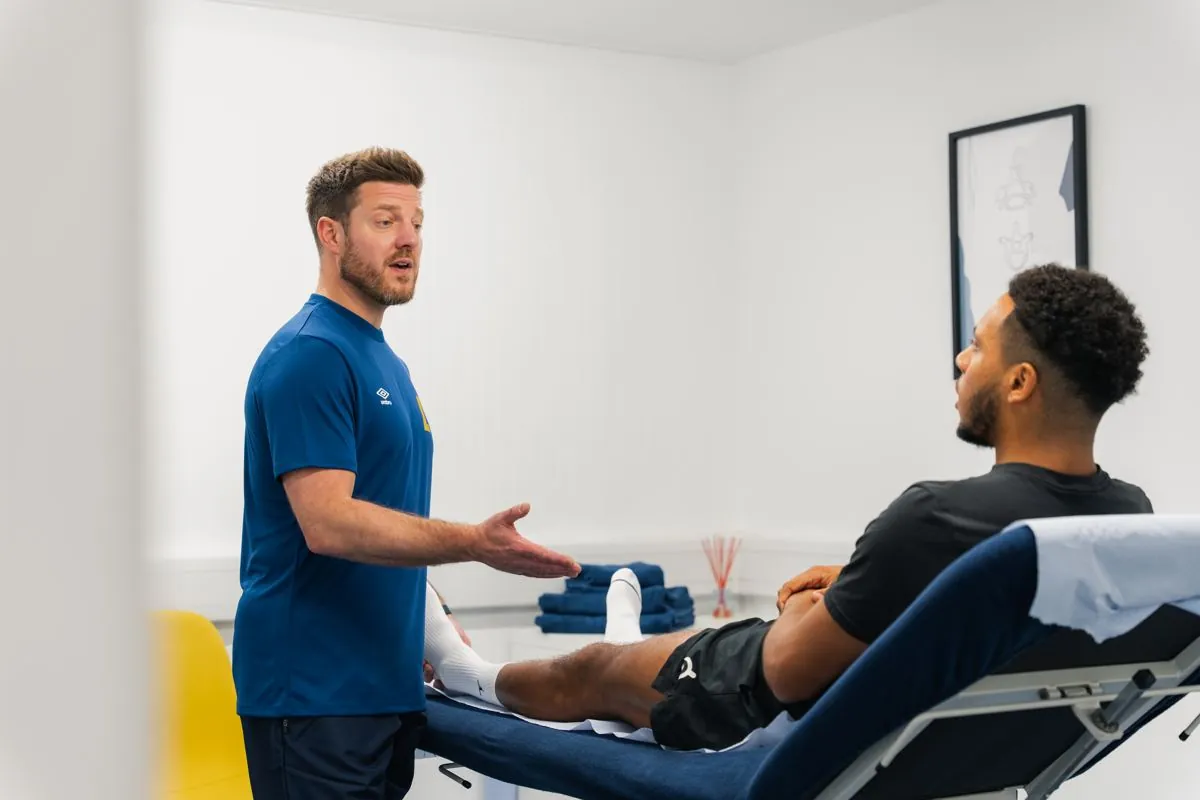 Practitioner discussing treatment with a client in a treatment room at Ascension Physiotherapy & Performance