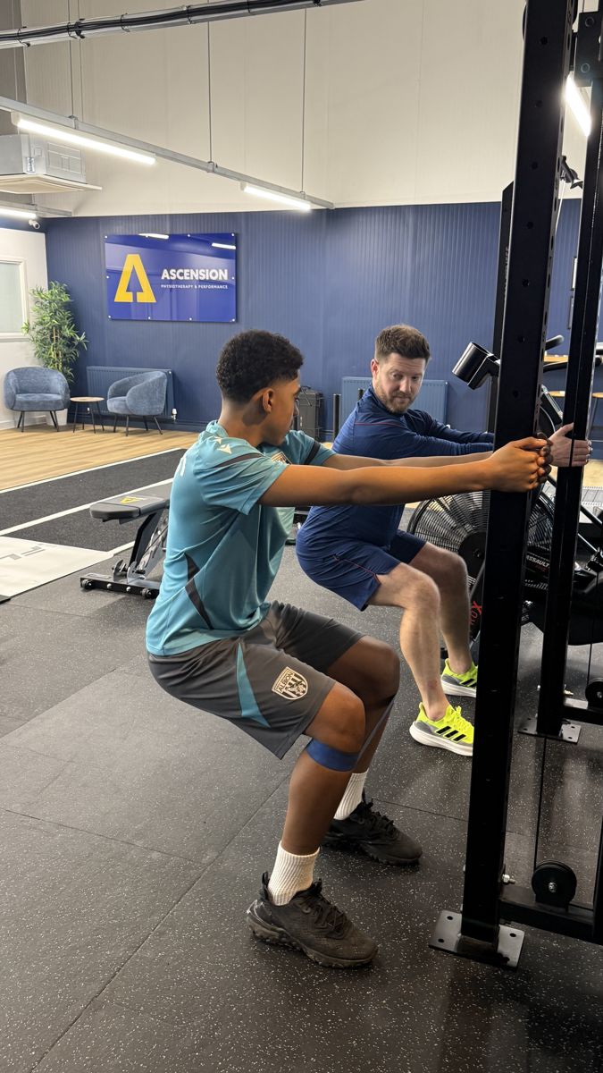 Young athlete performing a supervised strength exercise with an Ascension coach